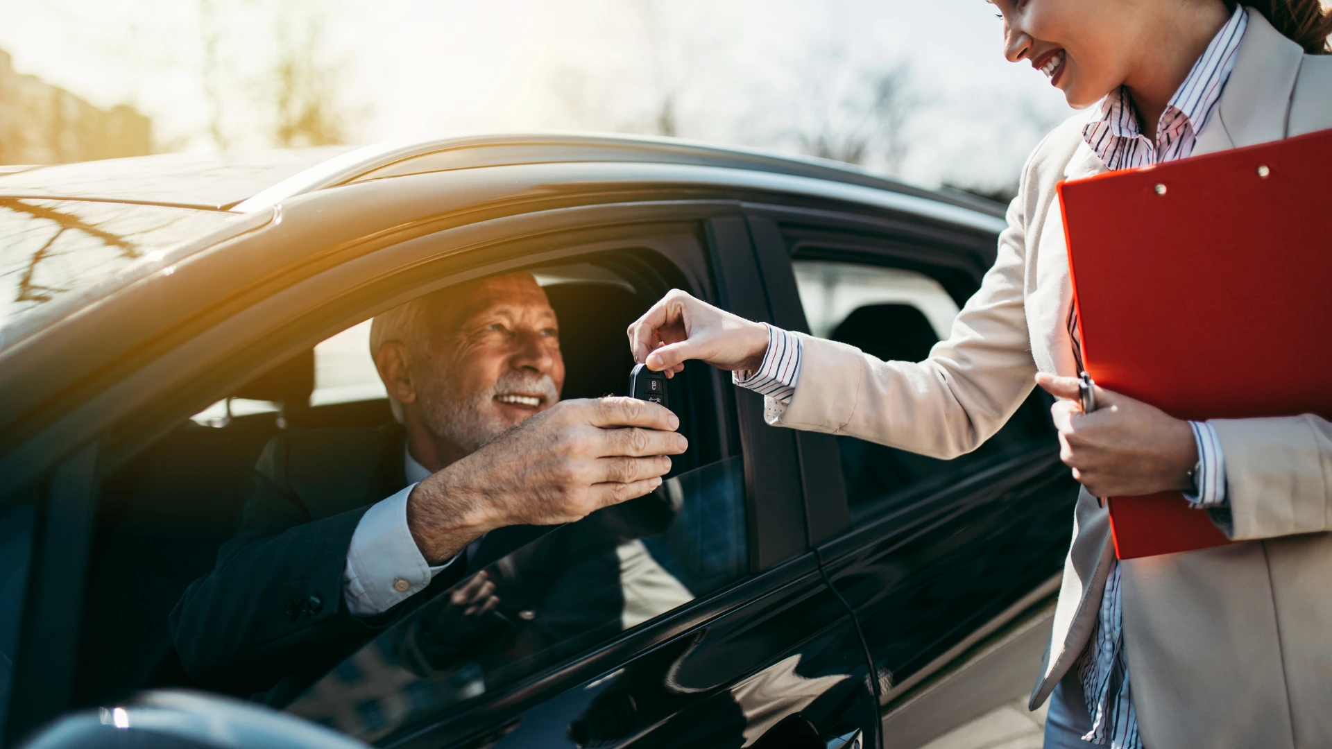 Girl handing over keys to the driver