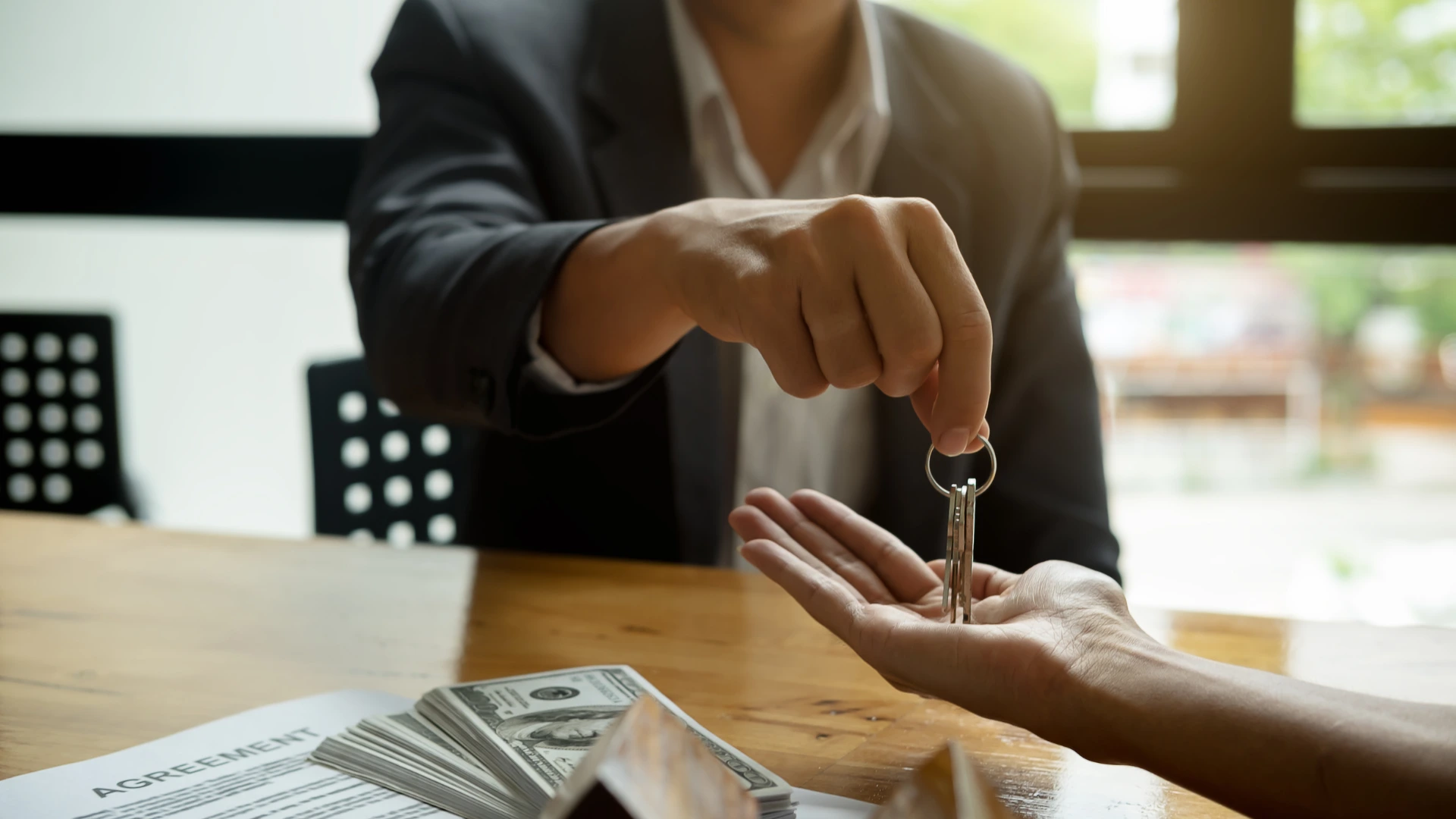 man handing keys to a buyer builds business partnership relationship
